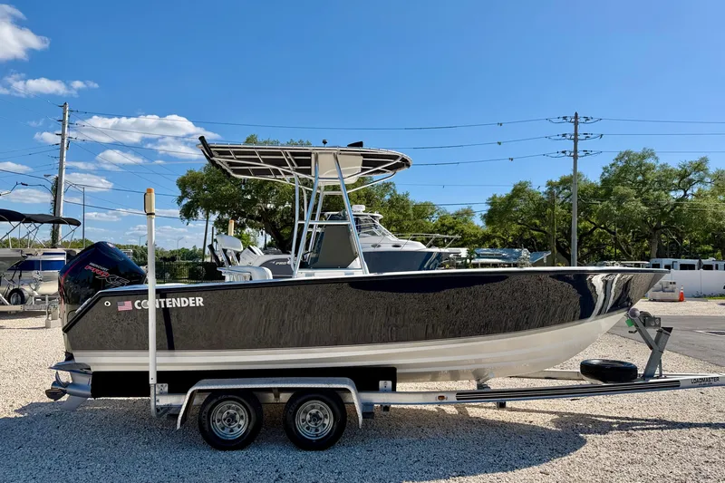 Slide: The Image of 2003 Contender 21 Open boat on trailer, parked outdoors under clear blue sky. - 7