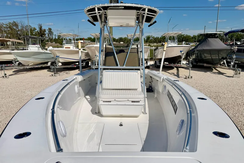Slide: The Image of 2003 Contender 21 Open boat with T-top, parked among other boats. - 9