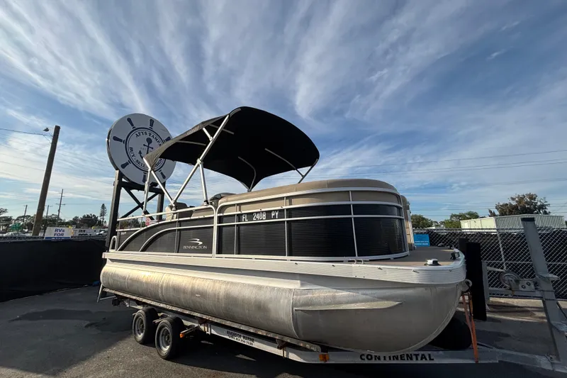 The Image of 2015 Bennington 20 SSX pontoon boat on trailer under a clear sky. - 0
