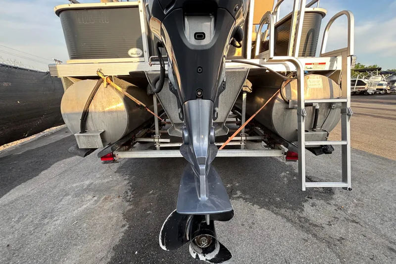 Slide: The Image of 2015 Bennington 20 SSX pontoon boat rear view with motor and ladder. - 14