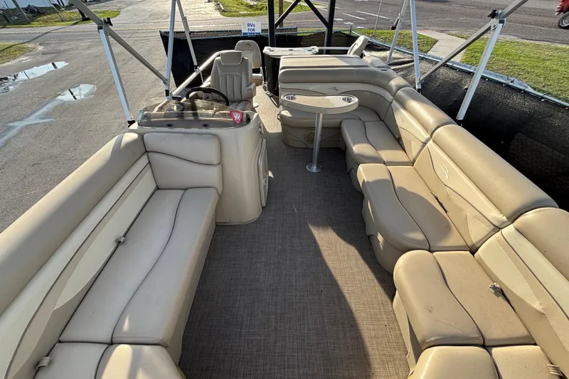 Slide: The Image of 2015 Bennington 20 SSX pontoon boat interior with beige seating and steering console. - 26