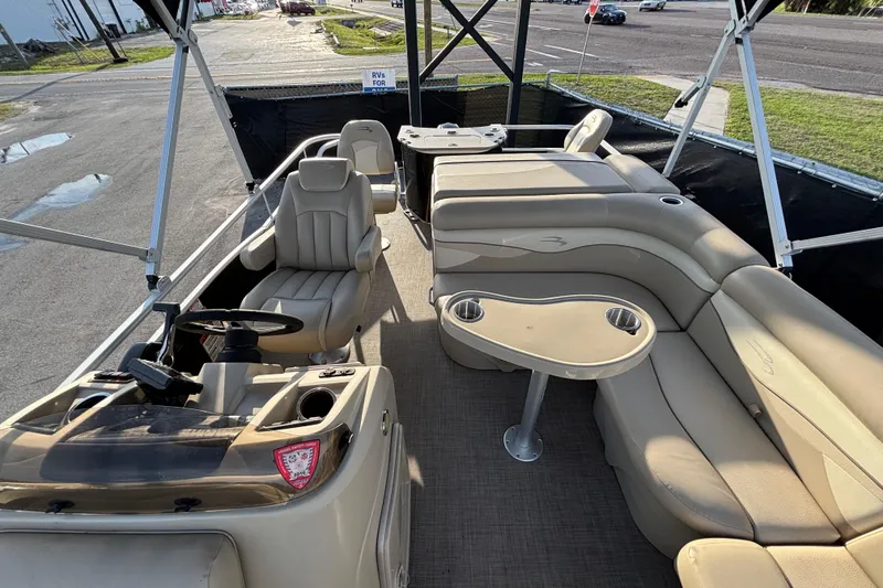 Slide: The Image of 2015 Bennington 20 SSX pontoon boat interior with beige seating and steering console. - 27