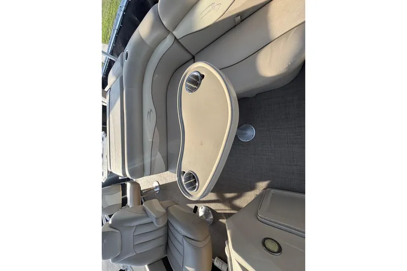 Slide: The Image of 2015 Bennington 20 SSX boat interior with beige seating and table. - 28