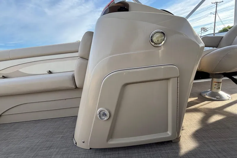 Slide: The Image of 2015 Bennington 20 SSX boat interior with beige seating and control panel. - 30