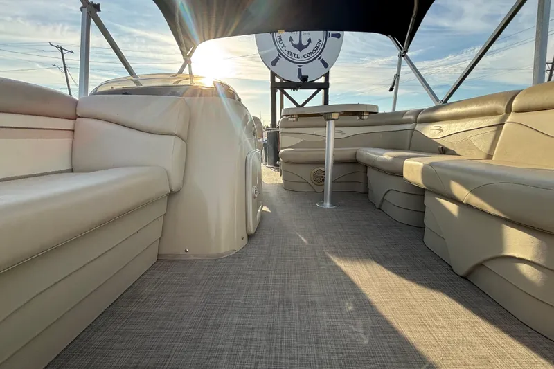Slide: The Image of 2015 Bennington 20 SSX pontoon boat interior with beige seating and sunlit canopy. - 33