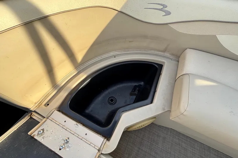 Slide: The Image of 2015 Bennington 20 SSX boat interior with storage compartment and seating. - 34