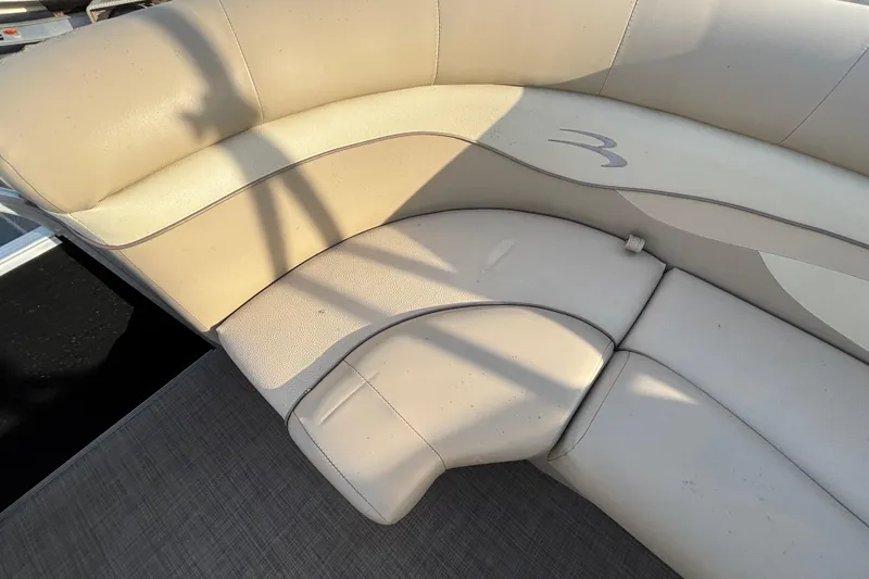 Slide: The Image of 2015 Bennington 20 SSX boat interior with beige cushioned seating. - 35