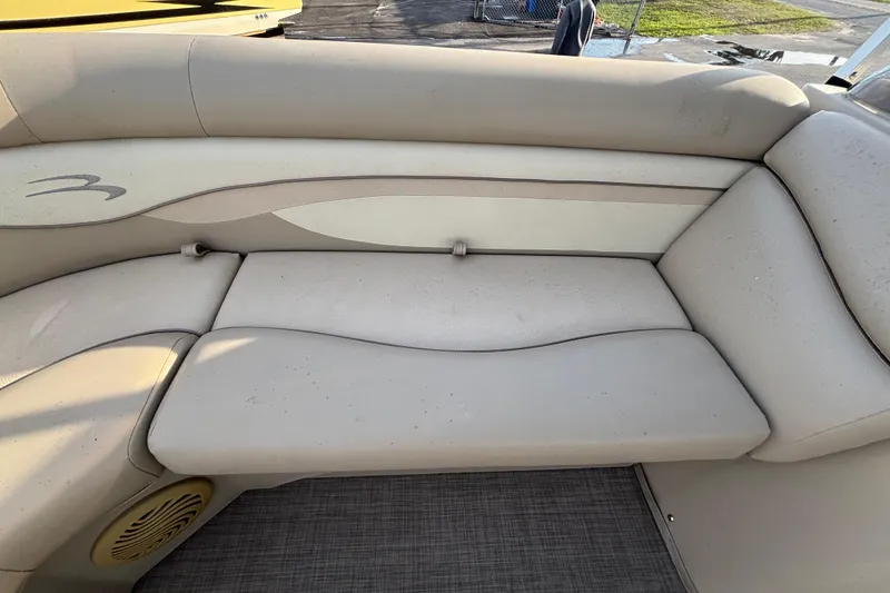 Slide: The Image of 2015 Bennington 20 SSX boat interior seating with beige upholstery. - 37