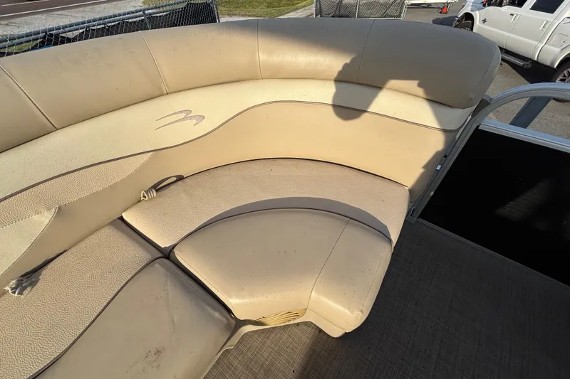 Slide: The Image of 2015 Bennington 20 SSX boat interior with beige seating and shadow. - 39