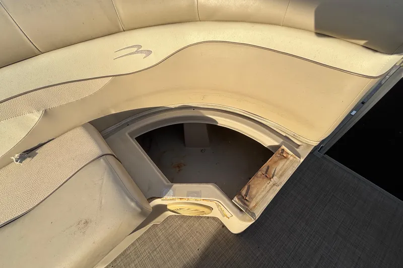Slide: The Image of 2015 Bennington 20 SSX boat seat with open storage compartment, beige upholstery. - 40