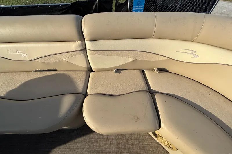 Slide: The Image of 2015 Bennington 20 SSX boat seating with beige upholstery and slight wear. - 41