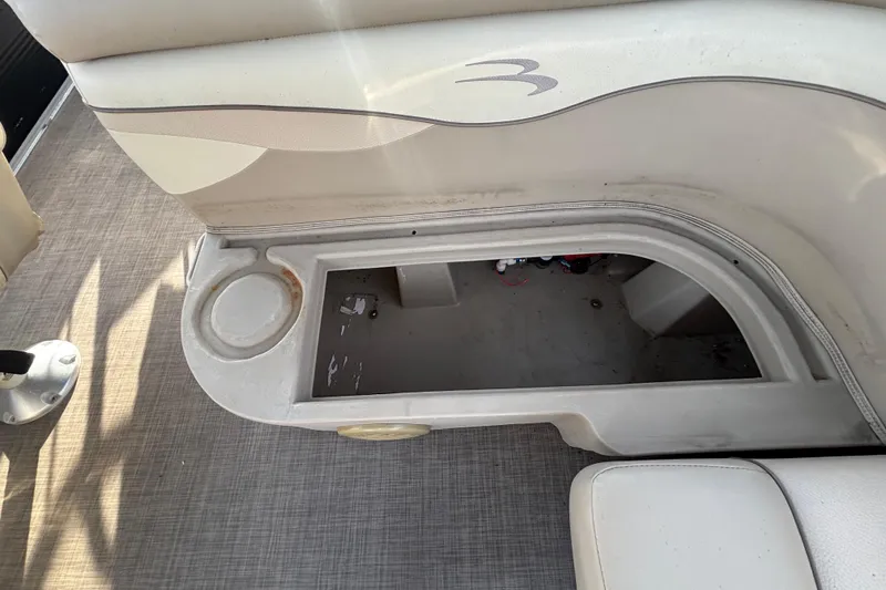 Slide: The Image of Open storage compartment on a 2015 Bennington 20 SSX boat seat. - 48