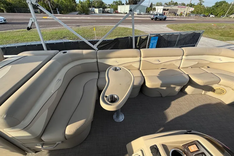 Slide: The Image of 2015 Bennington 20 SSX pontoon boat with beige seating and cup holders. - 49