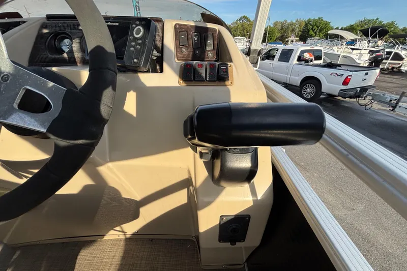 Slide: The Image of Control panel of a 2015 Bennington 20 SSX boat with steering wheel and throttle. - 50