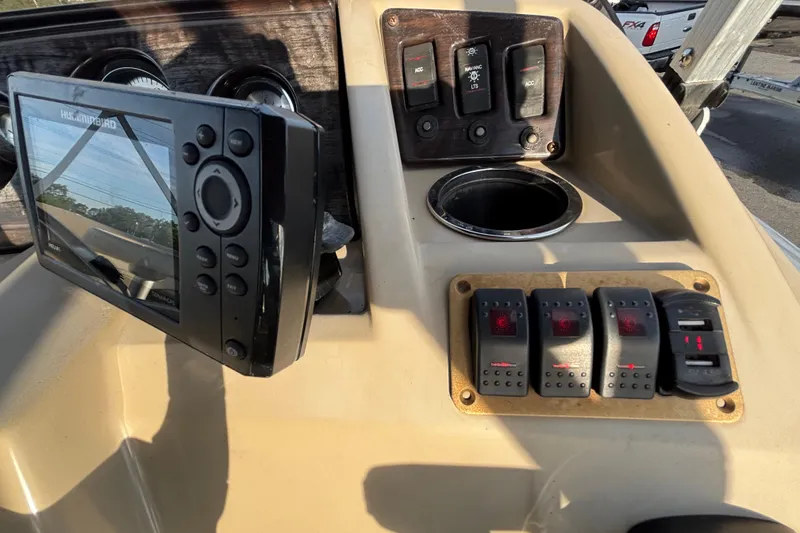 Slide: The Image of Control panel of a 2015 Bennington 20 SSX boat with switches and a display. - 51