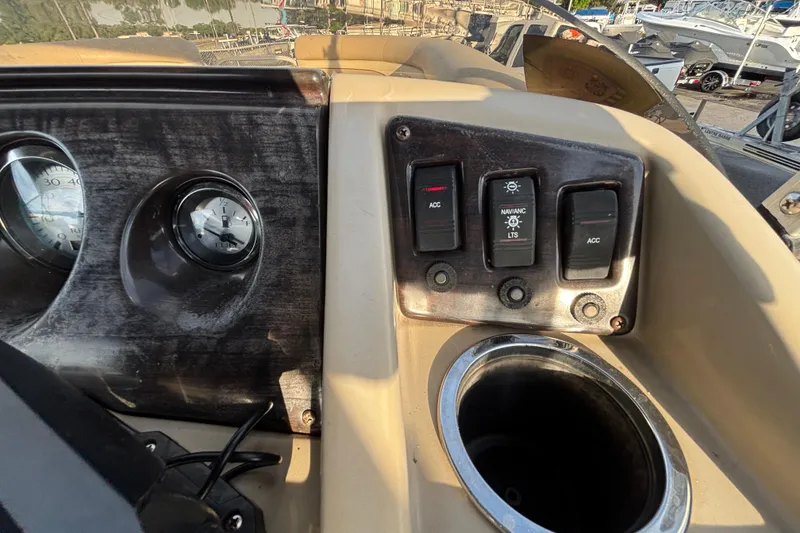 Slide: The Image of Dashboard controls of a 2015 Bennington 20 SSX boat with gauges and switches. - 52