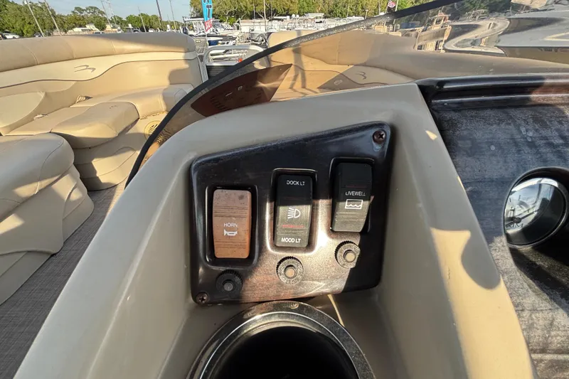 Slide: The Image of Control panel of a 2015 Bennington 20 SSX boat with switches and seating area. - 55