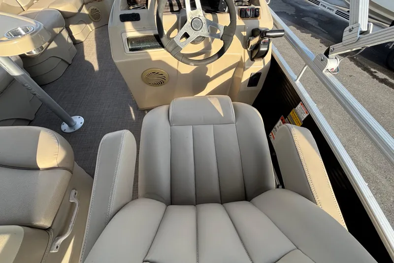 Slide: The Image of Interior of a 2015 Bennington 20 SSX boat with beige seating and steering wheel. - 56