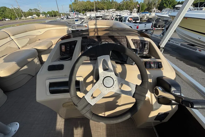 Slide: The Image of Steering console of a 2015 Bennington 20 SSX pontoon boat, featuring controls and seating. - 57
