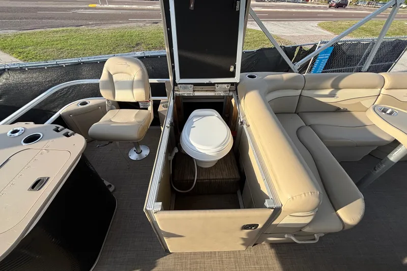 Slide: The Image of 2015 Bennington 20 SSX pontoon boat interior with seating and built-in toilet. - 61