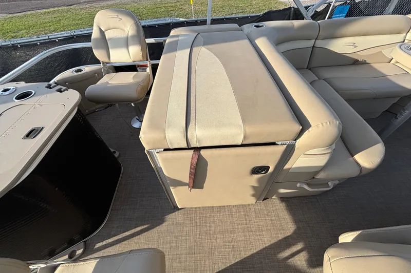 Slide: The Image of 2015 Bennington 20 SSX pontoon boat interior with beige seating and helm chair. - 62