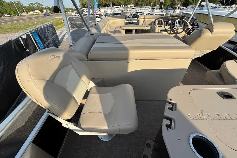 Slide: The Image of 2015 Bennington 20 SSX boat interior with beige seating and steering console. - 64