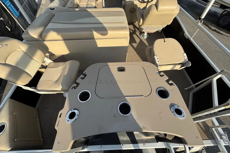 Slide: The Image of 2015 Bennington 20 SSX boat interior with beige seating and cup holders. - 65