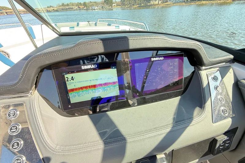 Slide: The Image of Dashboard of 2023 Chaparral 250 OSX boat with Simrad displays on a sunny day. - 13