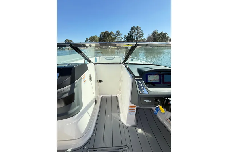 Slide: The Image of 2023 Chaparral 250 OSX boat interior with modern dashboard and lake view. - 17