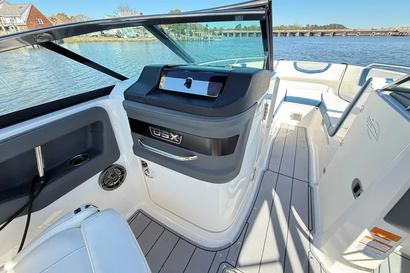 Slide: The Image of 2023 Chaparral 250 OSX boat interior with sleek design and modern features on a sunny day. - 20