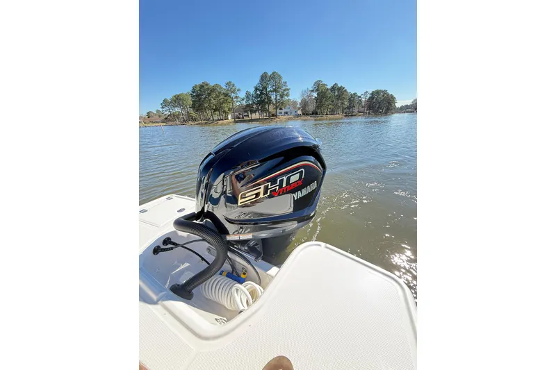 Slide: The Image of 2023 Chaparral 250 OSX boat with Yamaha engine on a sunny lake. - 26