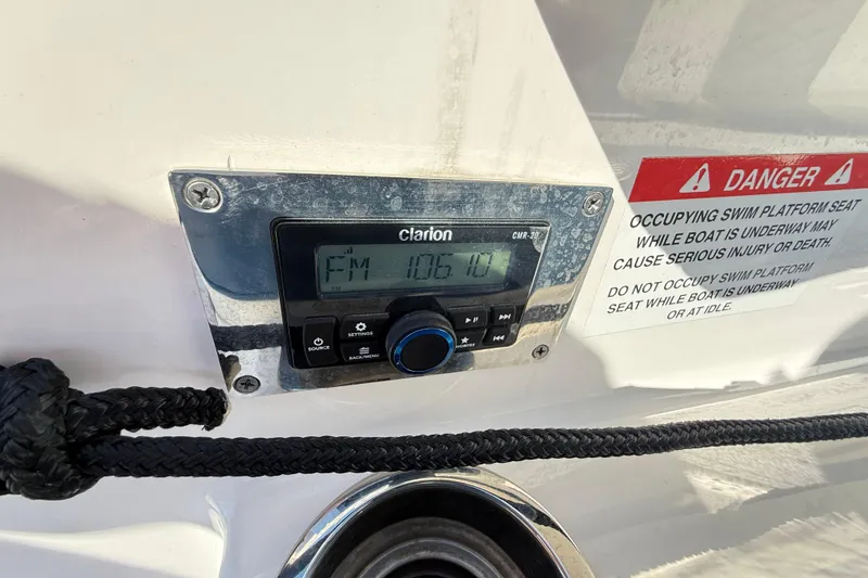 Slide: The Image of Clarion radio on 2023 Chaparral 250 OSX boat with safety warning label. - 30