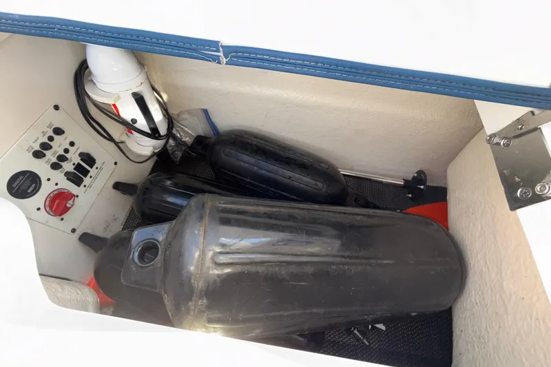 Slide: The Image of Storage compartment in 2023 Chaparral 250 OSX boat with fenders and control panel. - 32
