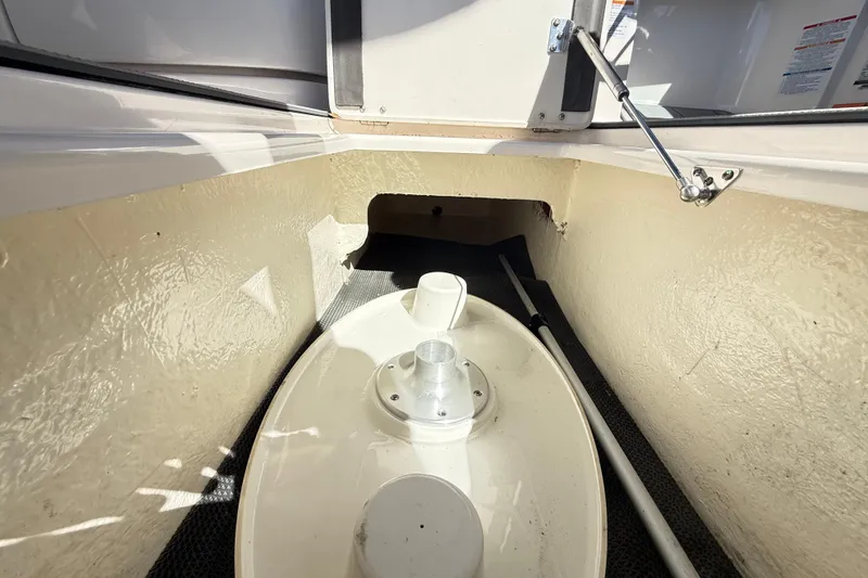 Slide: The Image of Storage compartment of 2023 Chaparral 250 OSX boat, featuring a hatch and interior components. - 38