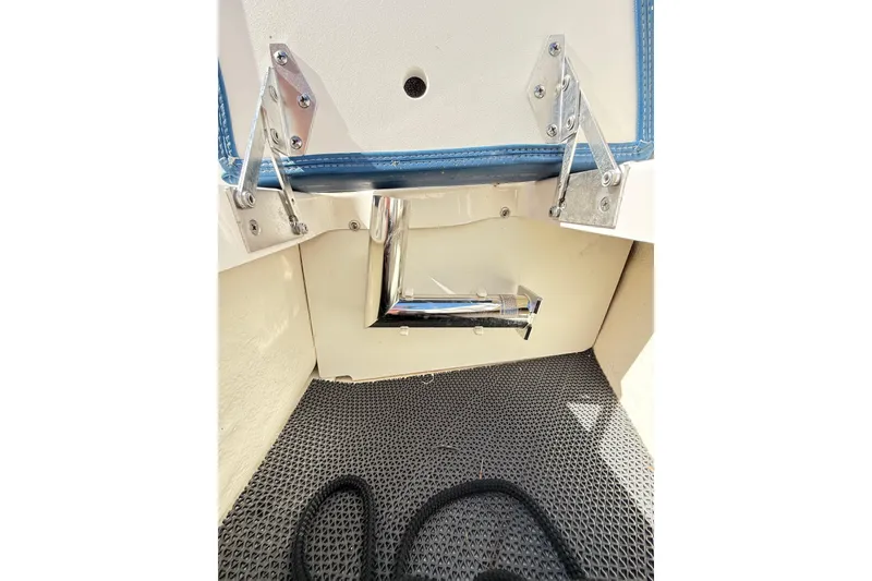 Slide: The Image of 2023 Chaparral 250 OSX boat interior detail with metal fittings and textured flooring. - 39