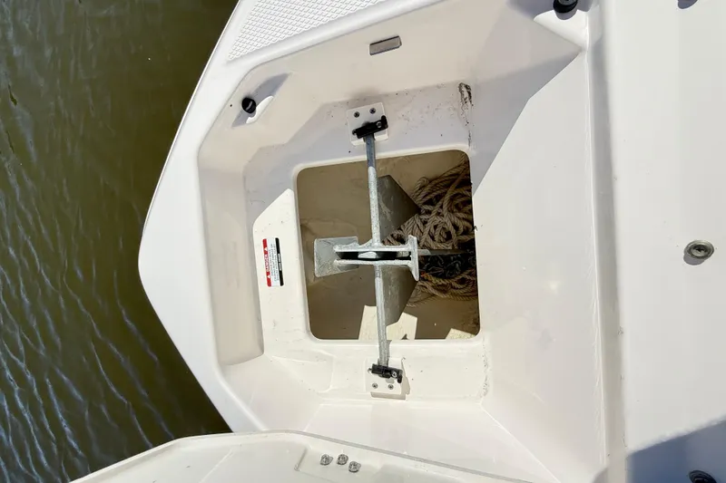 Slide: The Image of Anchor compartment of 2023 Chaparral 250 OSX boat with rope storage. - 40