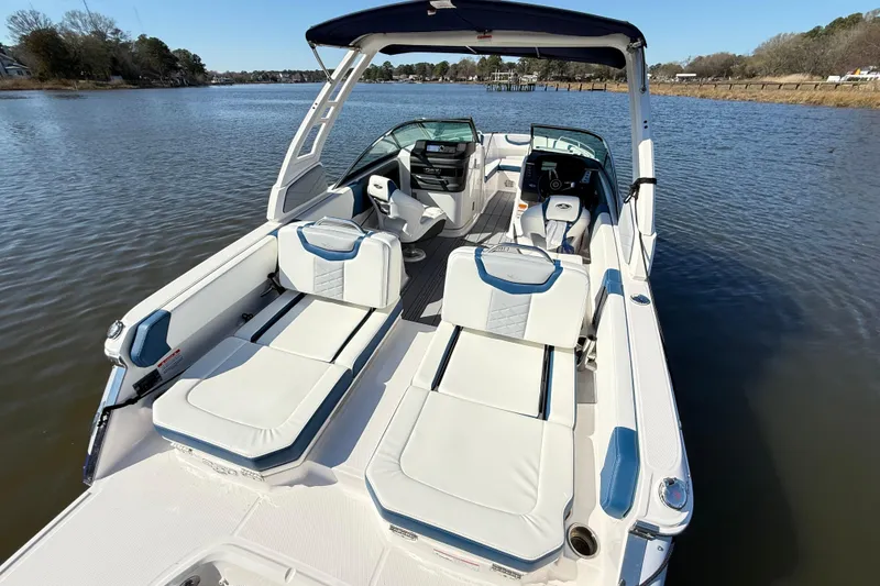 Slide: The Image of 2023 Chaparral 250 OSX boat with luxurious seating on a calm lake. - 6