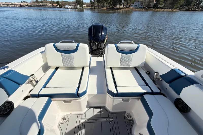 Slide: The Image of 2023 Chaparral 250 OSX boat interior with stylish seating on a calm lake. - 8