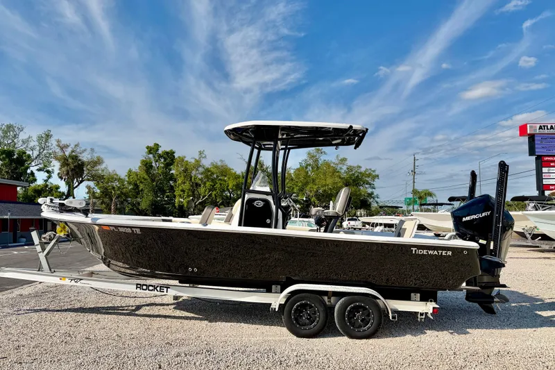 The Image of 2022 Tidewater 2300 Carolina Bay boat on trailer, parked outdoors under blue sky. - 0