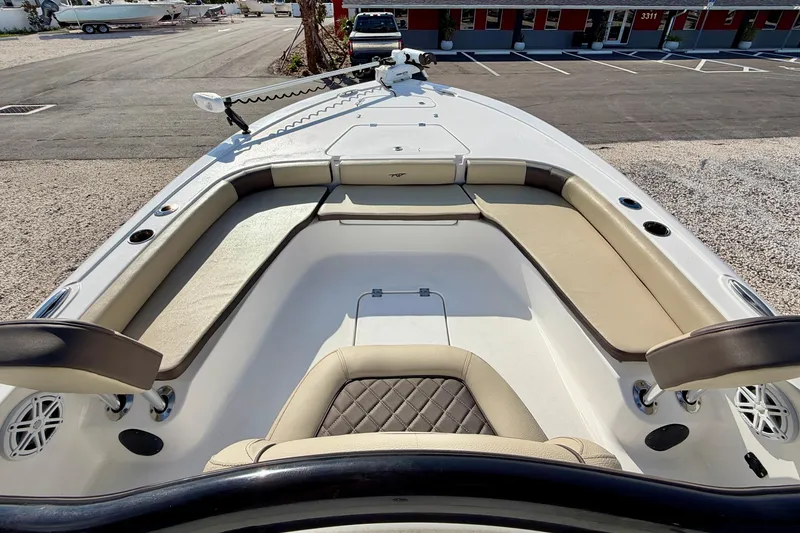 Slide: The Image of 2022 Tidewater 2300 Carolina Bay boat interior with cushioned seating and storage compartments. - 10