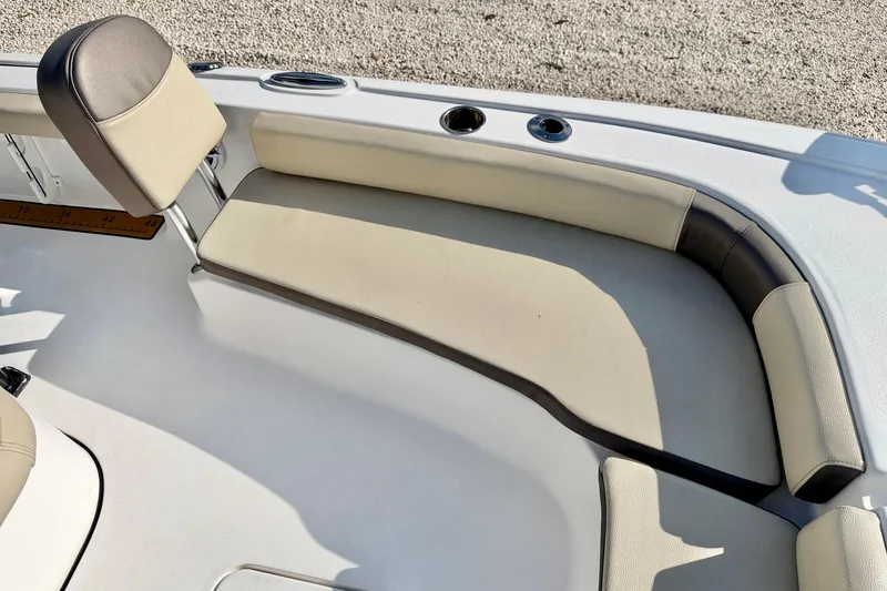 Slide: The Image of 2022 Tidewater 2300 Carolina Bay boat interior with beige seating and cup holders. - 12