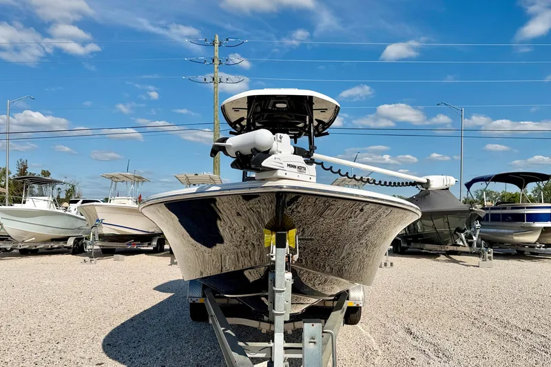 Slide: The Image of 2022 Tidewater 2300 Carolina Bay boat on trailer under clear blue sky. - 2