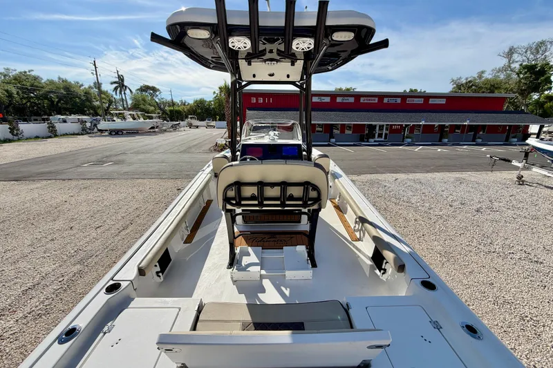 Slide: The Image of 2022 Tidewater 2300 Carolina Bay boat with seating and console, parked outdoors. - 28