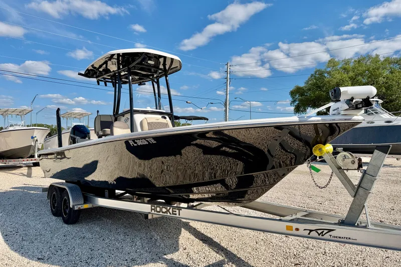 Slide: The Image of 2022 Tidewater 2300 Carolina Bay boat on trailer under blue sky. - 3