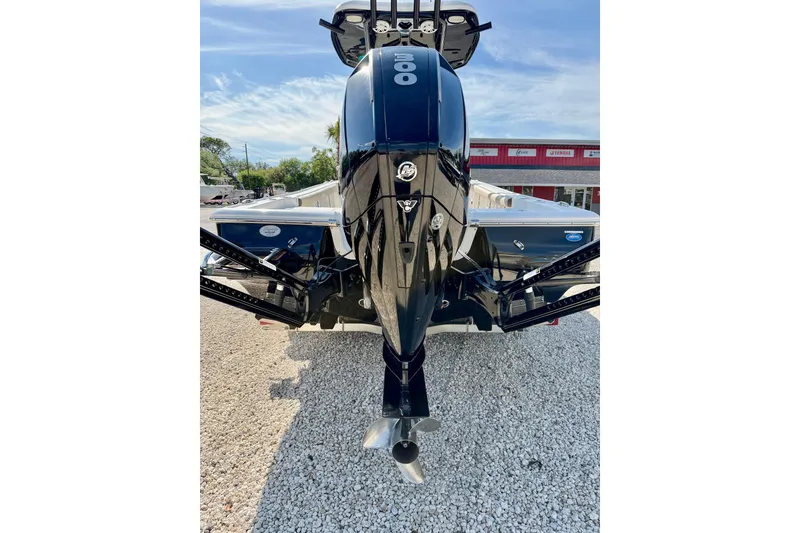 Slide: The Image of 2022 Tidewater 2300 Carolina Bay boat with powerful outboard motor, parked on gravel. - 35