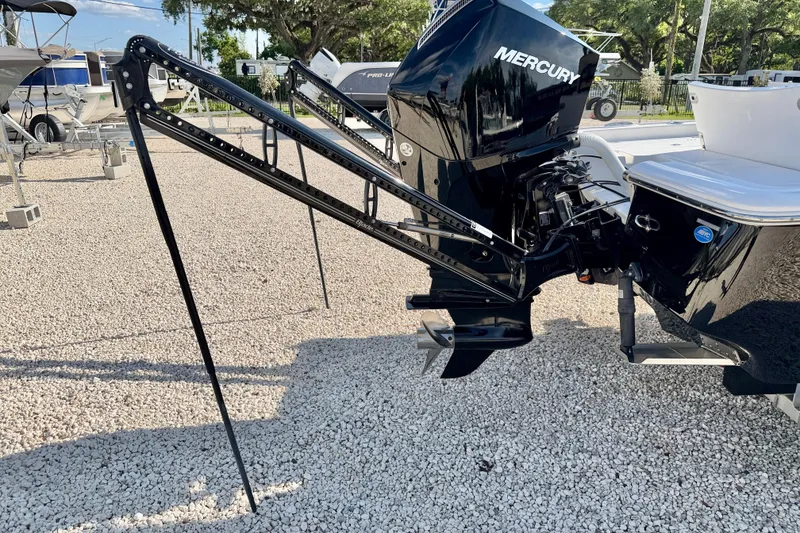 Slide: The Image of 2022 Tidewater 2300 Carolina Bay boat with Mercury engine and power poles on gravel. - 39