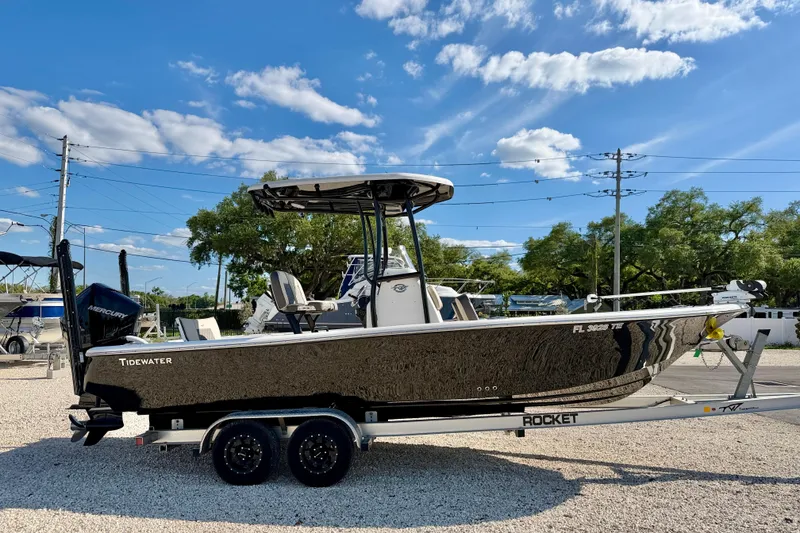 Slide: The Image of 2022 Tidewater 2300 Carolina Bay boat on trailer under blue sky. - 4