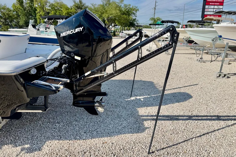 Slide: The Image of 2022 Tidewater 2300 Carolina Bay boat with Mercury engine and power poles on gravel lot. - 40