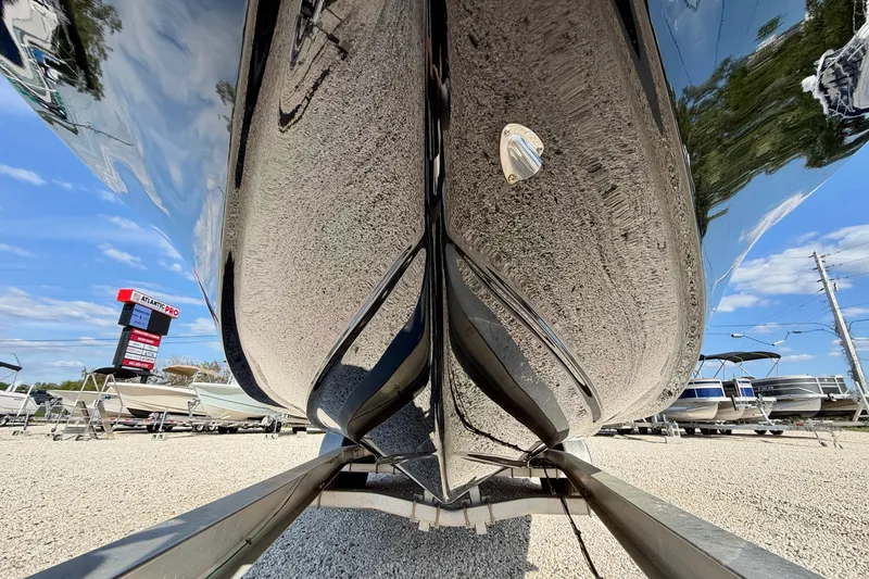 Slide: The Image of Close-up of 2022 Tidewater 2300 Carolina Bay boat hull on trailer, reflecting sky and surroundings. - 41