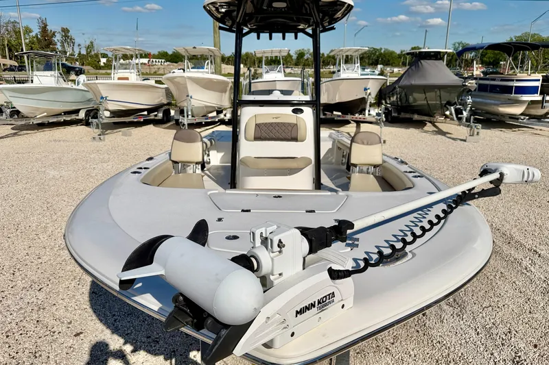 Slide: The Image of 2022 Tidewater 2300 Carolina Bay boat with Minn Kota trolling motor, parked among other boats. - 8